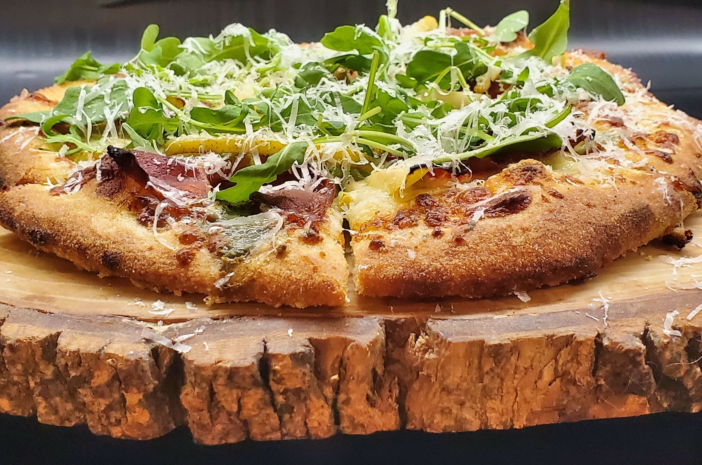 A pizza on a wooden board.
