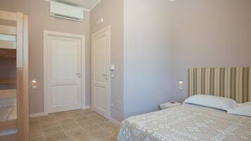 A bedroom with a bed, a wardrobe, and a door.