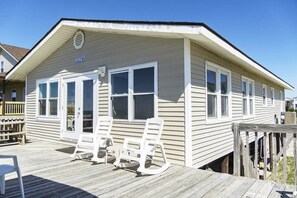 Relax on the front porch with two comfortable chairs and a small table.