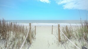 A beach path leading to the ocean with wooden posts and rope barriers. - Rhoney R&R: Oceanfront Home With Two Living Rooms (Oak Island)