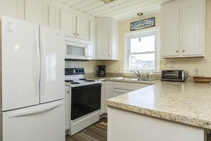 Enjoy cooking in this well-equipped kitchen with a microwave, stovetop, and toaster oven.