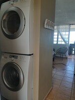 A laundry area with two stacked washing machines.