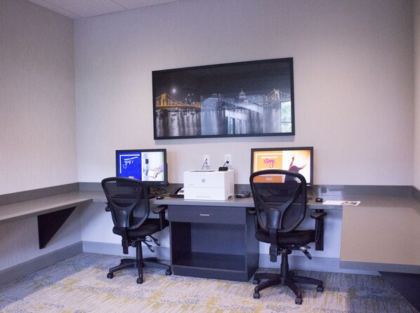 A workspace with two desks, each with a computer monitor, a printer, and a chair. - Hampton Inn & Suites Cranberry Pittsburgh (Cranberry Township)