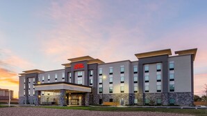 A modern hotel with a flat roof, multiple floors, and a prominent entrance. - Hampton Inn & Suites Guymon (Guymon)