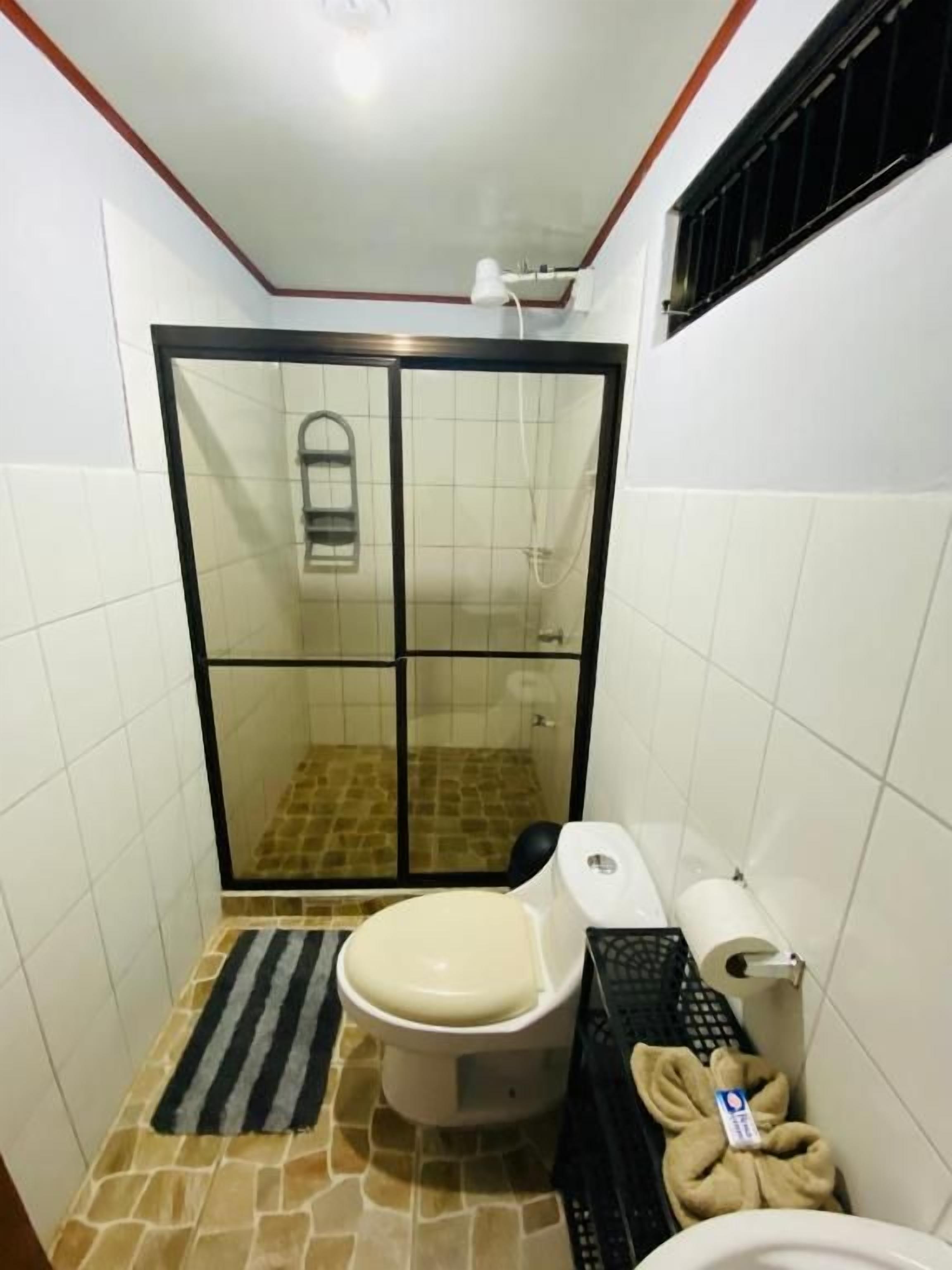 Shower, rainfall showerhead, soap, toilet paper
