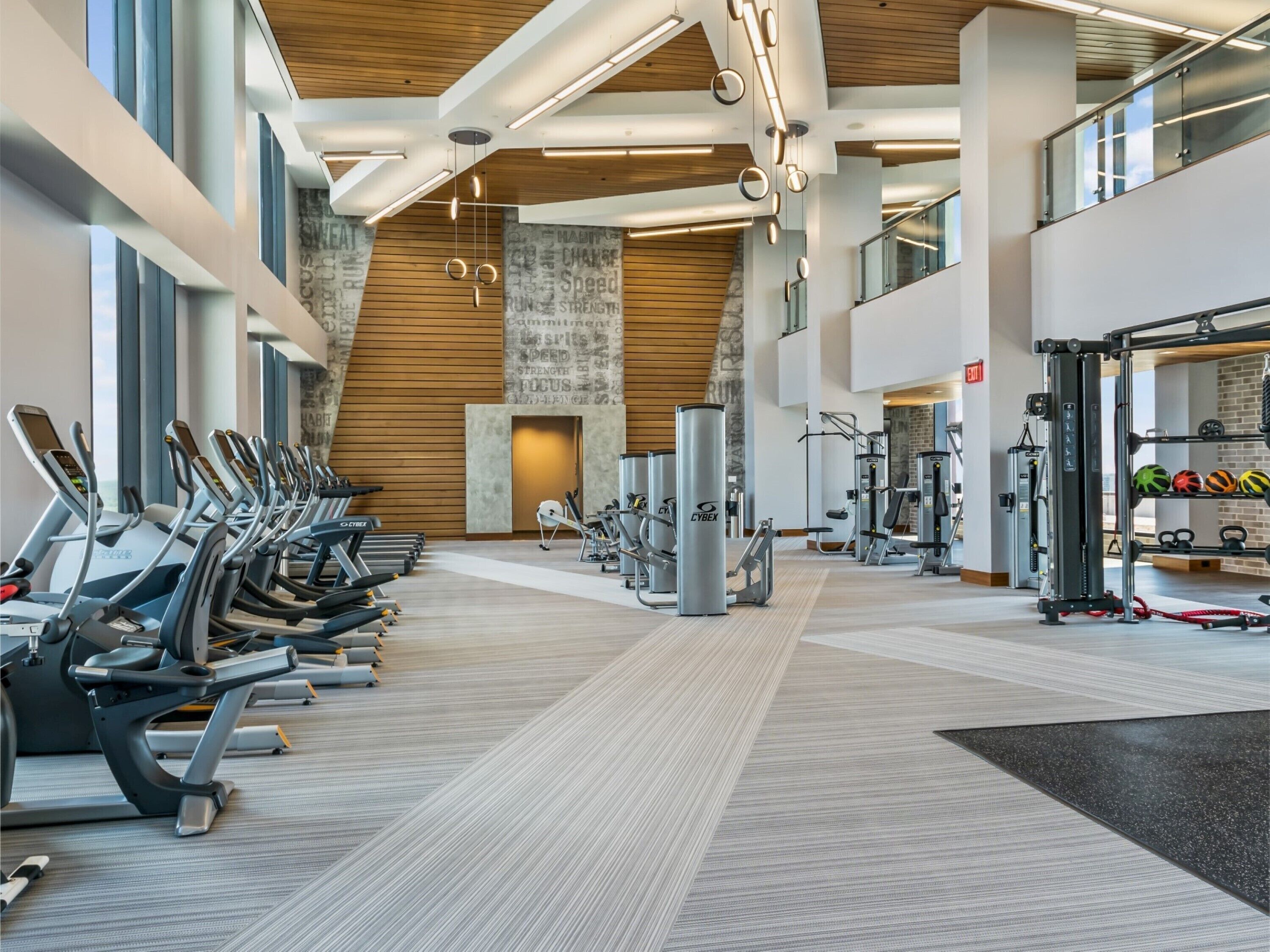 A modern gym with treadmills, weight machines, and a variety of fitness equipment.