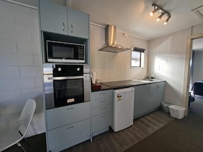 Family Apartment | Private kitchen | Mini-fridge, microwave, coffee/tea maker, electric kettle