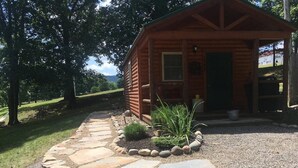 A log cabin with a stone pathway leading to the entrance. - 1 Queen size bed &Love seat sofa, Creek view (Shamokin)