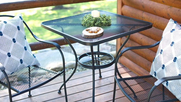 A wooden deck with a metal table and two chairs, each with a patterned cushion. - 1 Queen size bed &Love seat sofa, Creek view (Shamokin)