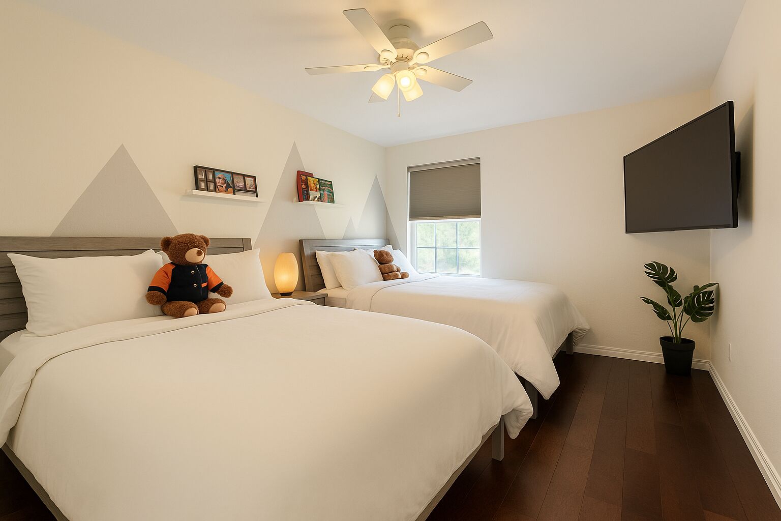 A hotel room with two beds, a ceiling fan, a TV, and a potted plant.