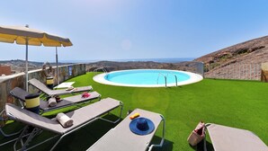 A rooftop pool area with artificial grass, sun loungers, and a view of the ocean. -  Los Lagos 39 Salobre Golf (Maspalomas)