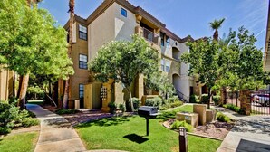 A residential building with a central courtyard, surrounded by trees and a paved walkway. - Quiet 1st Floor, Gated, Pool, Wi-Fi, Free Parking, Gym (Phoenix)