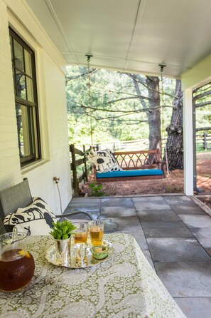 Porch swing under the shade of the pines
