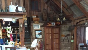 Ein rustikales Interieur mit Holzwänden, einem Holztisch und einem Stuhl.