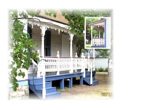 Stroll up to this charming two-story home with a welcoming porch and white columns.