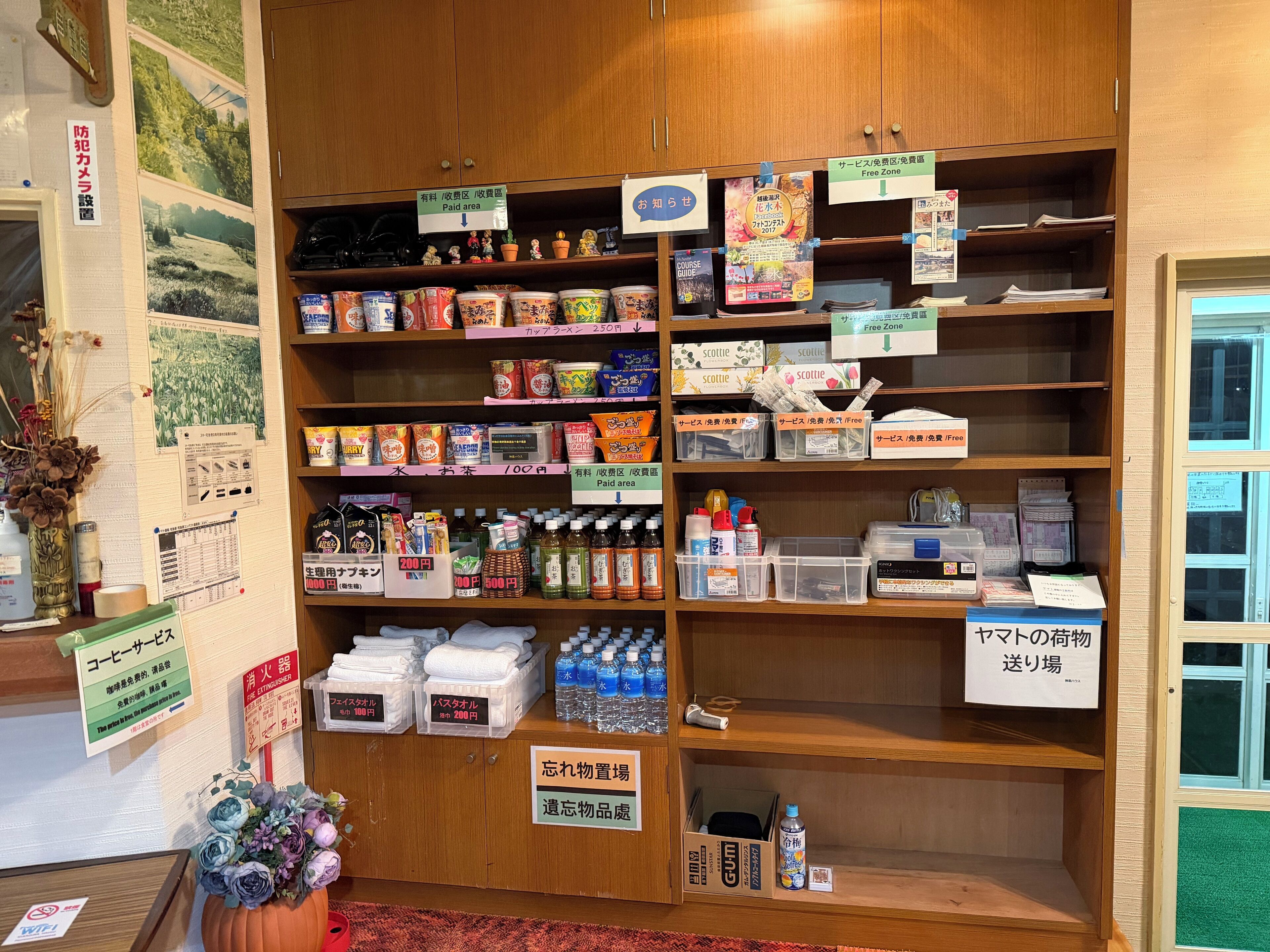A store with shelves stocked with various products, price tags, and signs indicating different sections.
