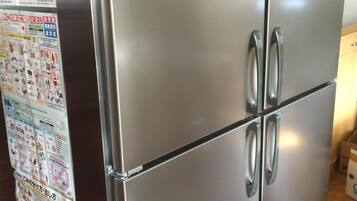 A stainless steel refrigerator with four doors, a built-in ice maker, and a freezer compartment.