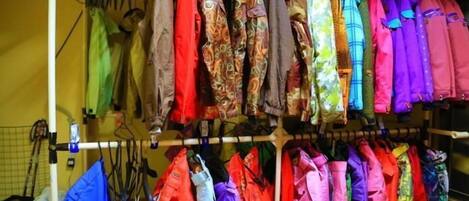 A rack of colorful jackets hanging in a store.