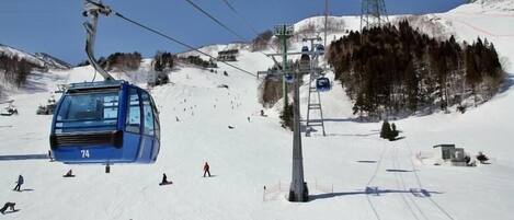 A ski lift with a cable car moving along the track.