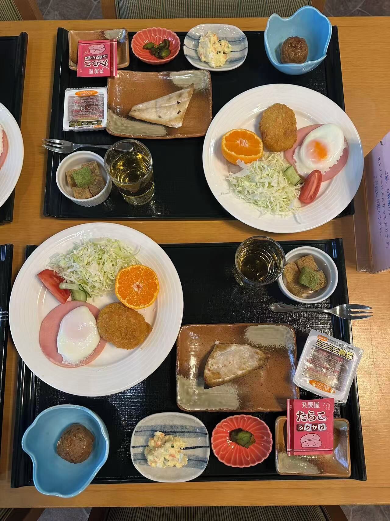 Eine Servietta mit verschiedenen Speisen, darunter ein Teller mit Spiegelei, Gemüse und einer kleinen Schale Suppe.