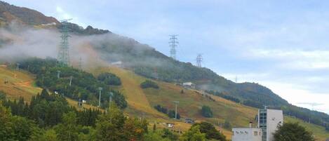 A mountainous landscape with a building and power lines.