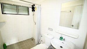 Un baño pequeño con inodoro, lavabo y ducha.