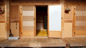 A traditional Japanese building with wooden doors and a stone-paved entrance. - Doldam House (Jeonju)