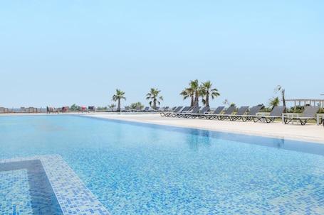 Seasonal outdoor pool, open 11 AM to 6:00 PM, pool umbrellas