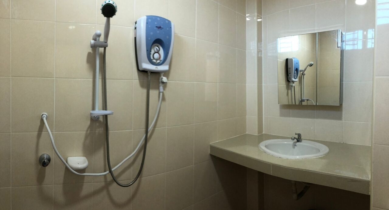 A bathroom with a shower, a sink, and a mirror.