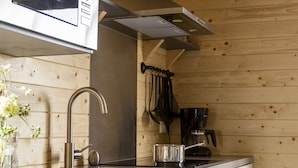 A modern kitchen with a stainless steel microwave, dishwasher, and sink.