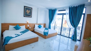 A hotel room with two beds, a balcony with blue curtains, and a framed picture on the wall. - Tea Leaf Hotel (Cam Ly - Da Lat)