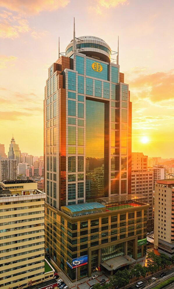 A high-rise building with a distinctive top section and a lower section with a covered area. - Asia International Hotel Guangzhou (Guangzhou)
