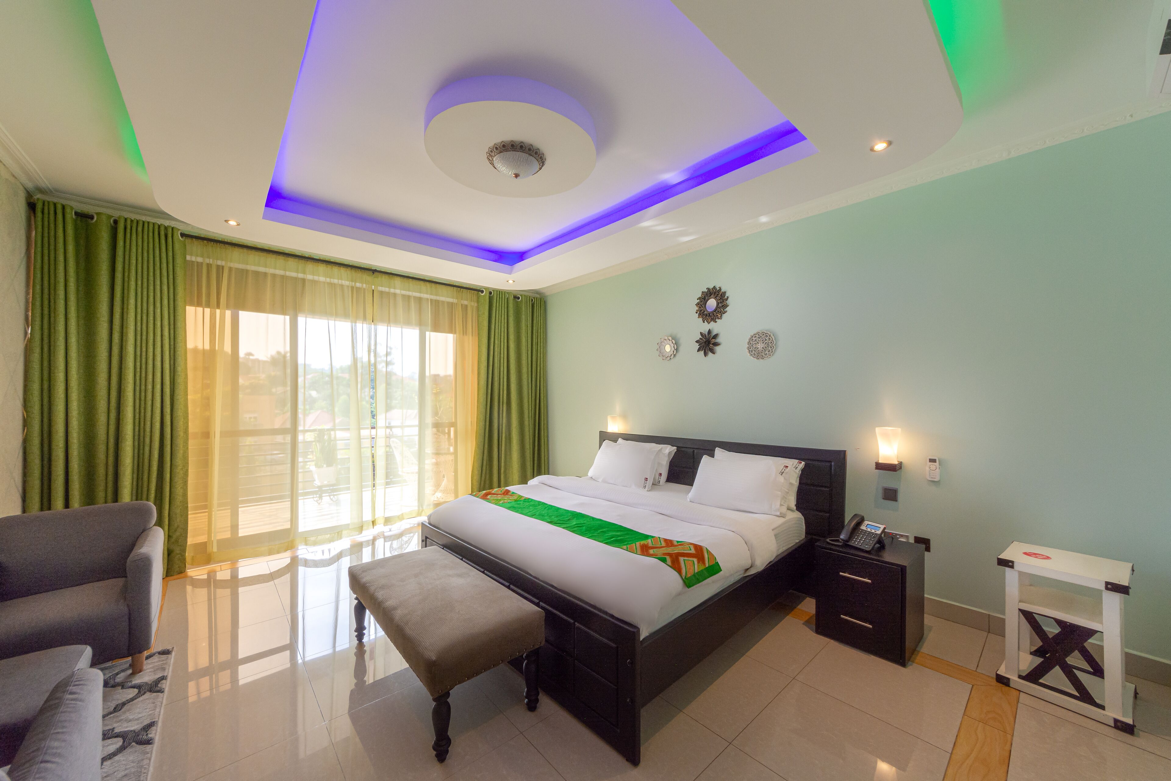 A modern bedroom with a bed, bedside table, and a bench.