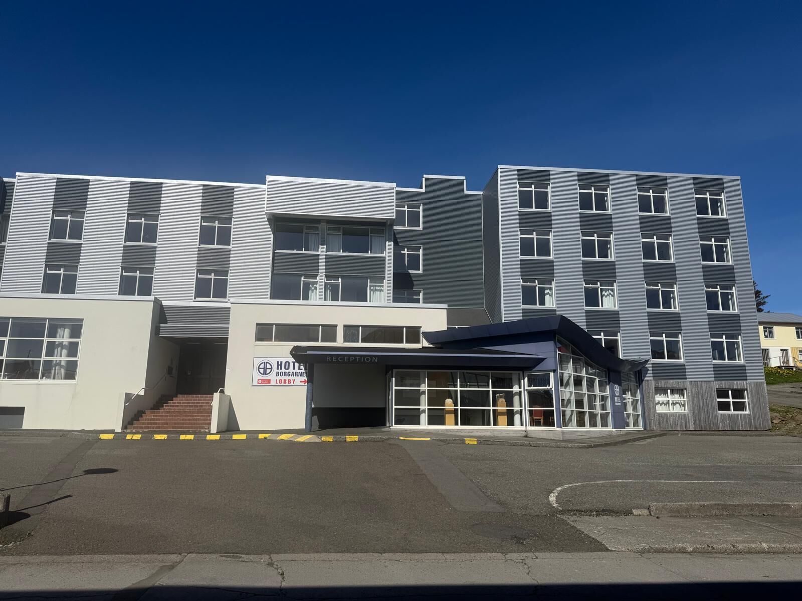 A modern hotel with a reception area and a lobby.