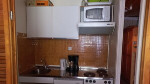 A compact kitchen with a sink, stove, and microwave. - Studio at the foot of the slopes with south balcony in Tignes (Tignes)