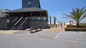 A building with a sloped roof, a staircase leading to a balcony, and a bench in the foreground. - 🏝️🏖️Sandpiper Cove, Private Beach Access Overlooks Heated Pool (Destin)