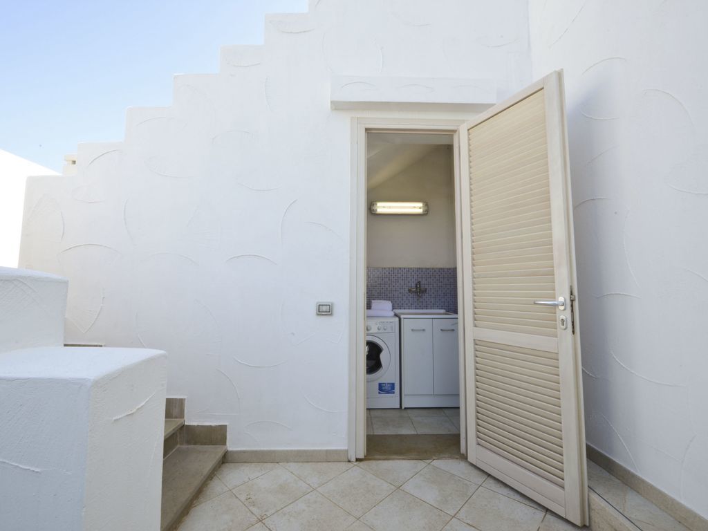 A compact laundry room with a washing machine, dryer, and a small countertop.