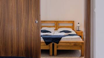 A bedroom with a wooden bed, a nightstand, and a wardrobe.