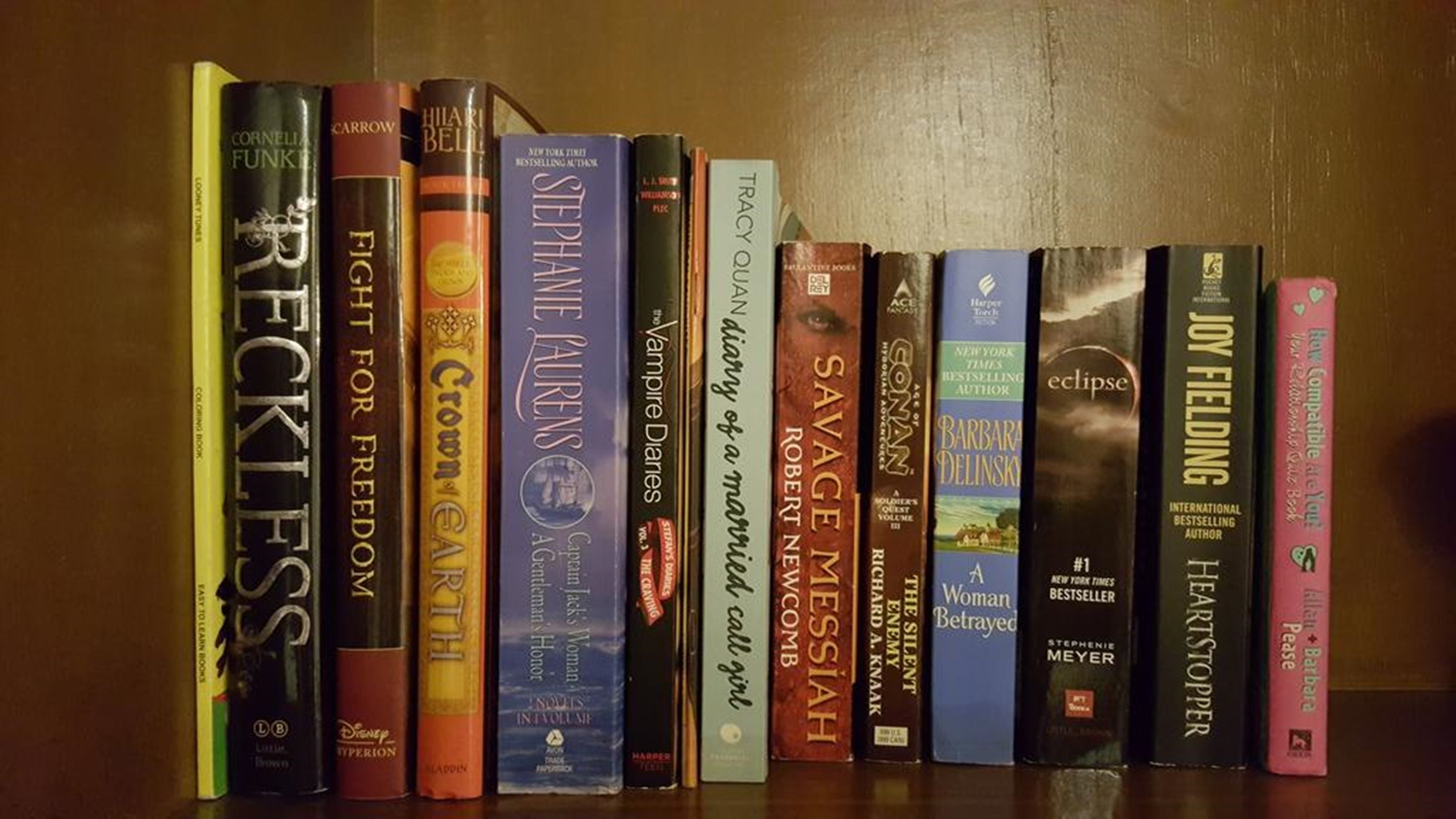 A bookshelf with various books.
