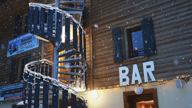A wooden building with a spiral staircase and a sign that reads "BAR". - 1861 Châtel Hostel (Chatel)