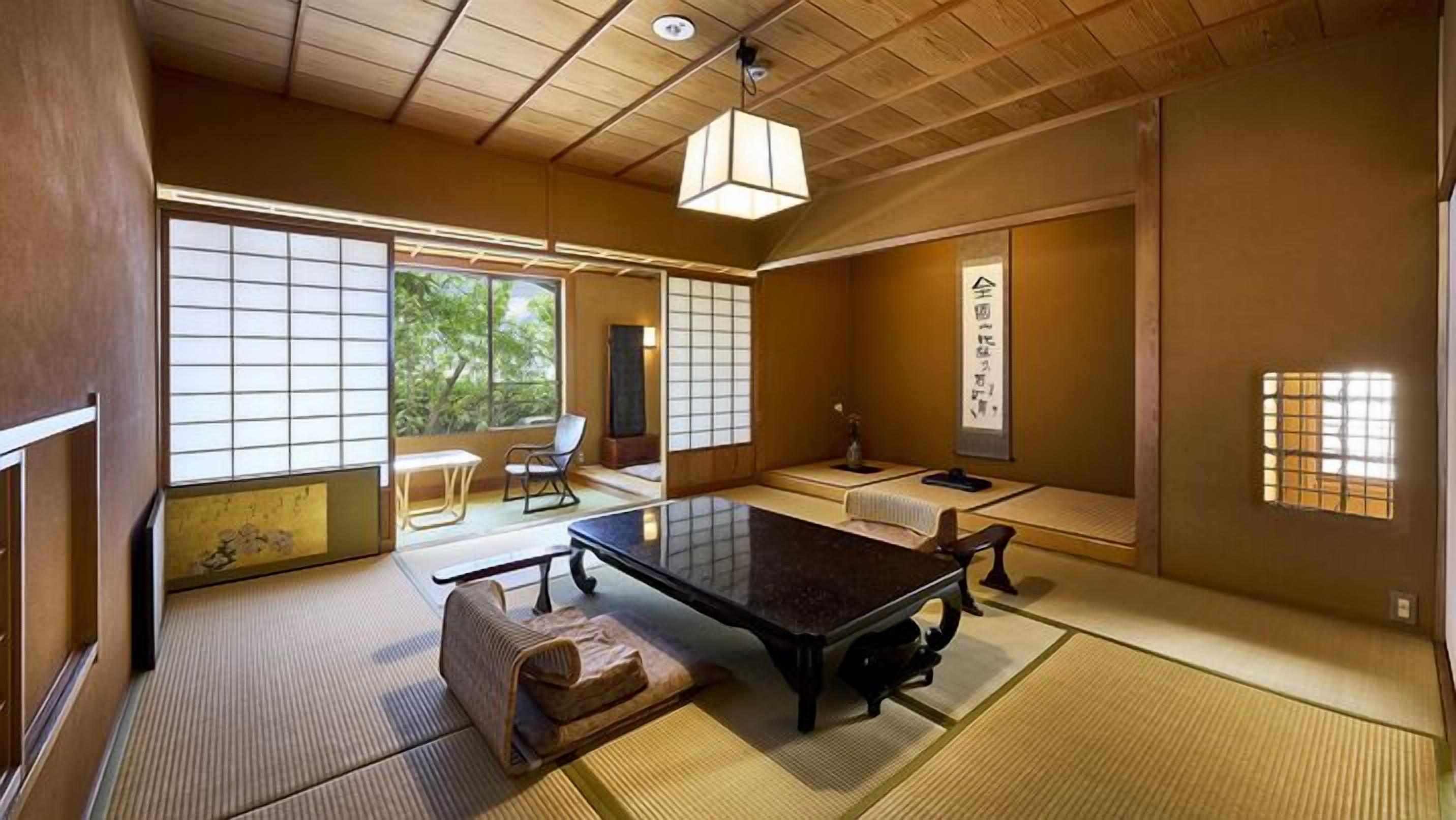 A traditional Japanese room with tatami flooring, a low table, and sliding doors.