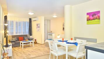 Deluxe Studio, Balcony | Living area | Flat-screen TV