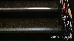 A staircase with a metal railing and a hole in the wall. - The Metropolis Guest House Near RK Ashram Metro Station (New Delhi)