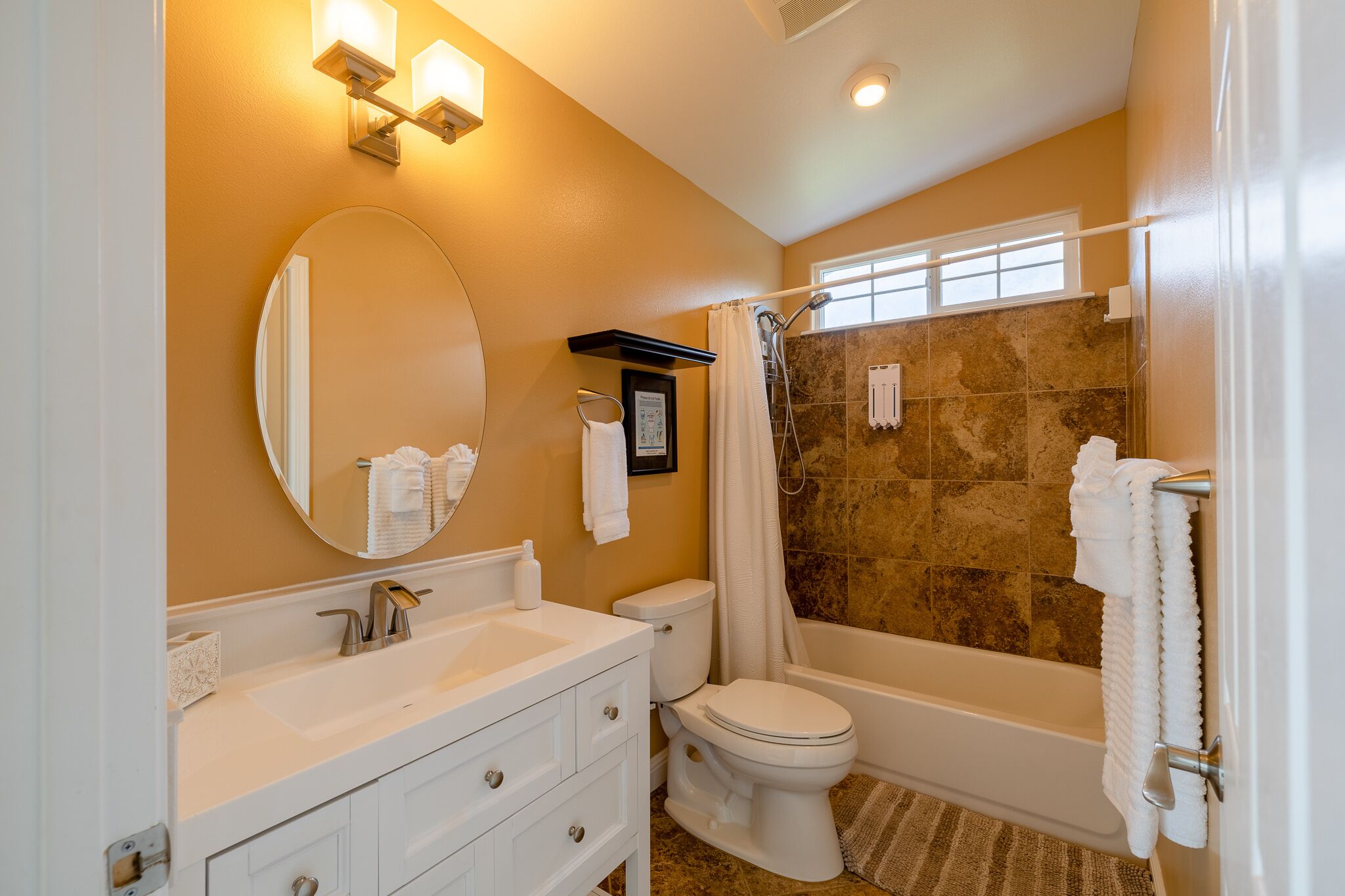 A bathroom with a sink, toilet, and bathtub.