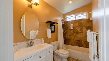 A bathroom with a sink, toilet, and bathtub.