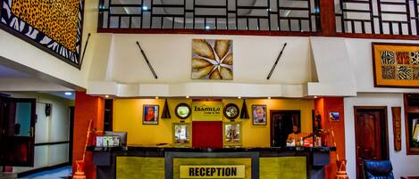 A reception area with a reception desk, a clock, and a framed picture on the wall.