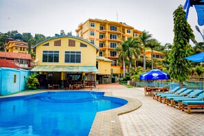 Outdoor pool, open 6 AM to 7 PM, pool umbrellas