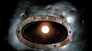 A close-up of a metallic surface with a circular opening and rivets. - The Black Hole (Winchester)