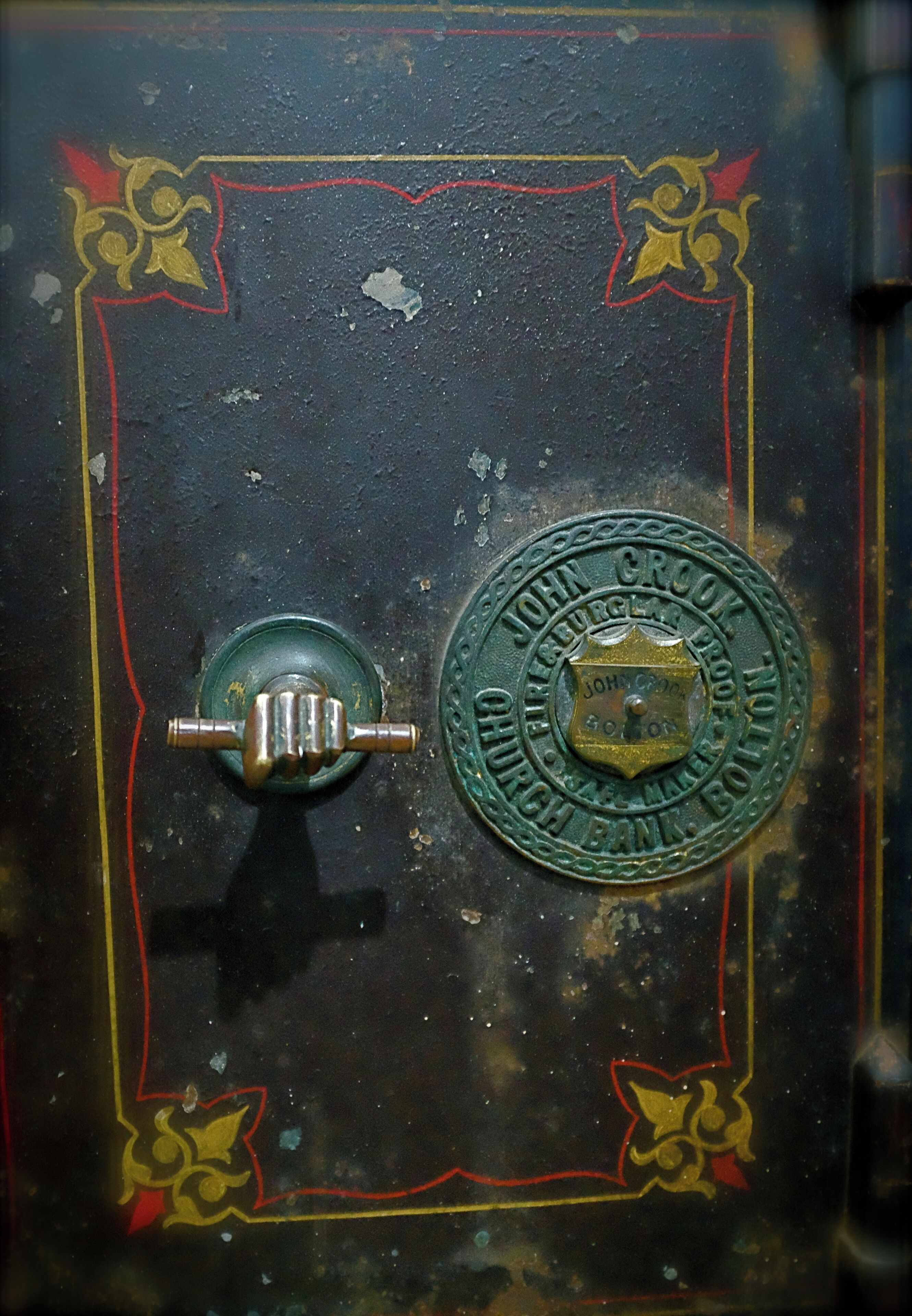 A metal lock with a circular emblem that reads "John Crook Church" and a keyhole.