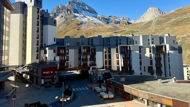 A modern hotel with a ski lift and mountain views.